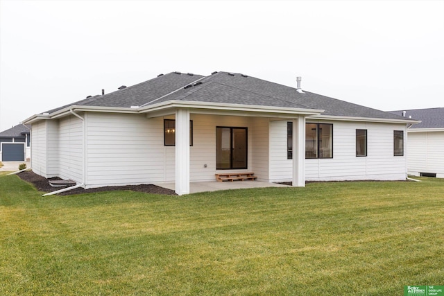 rear view of house featuring a patio area and a lawn