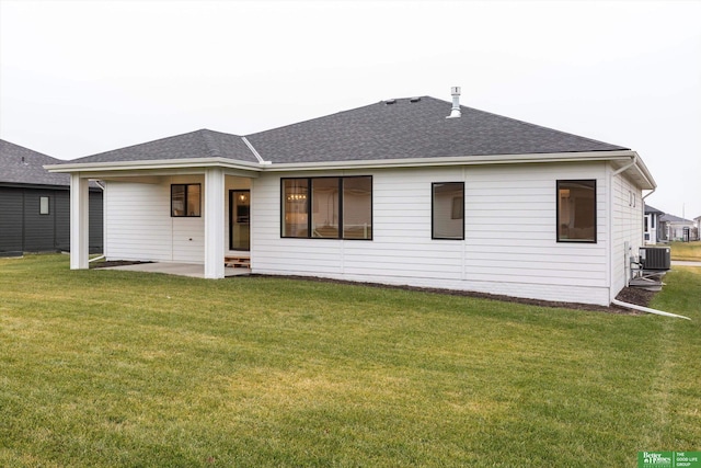 rear view of property featuring central air condition unit, a patio area, and a yard