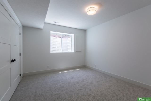 unfurnished bedroom with carpet, visible vents, and baseboards