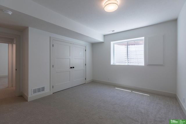 unfurnished bedroom with carpet floors, a closet, visible vents, and baseboards