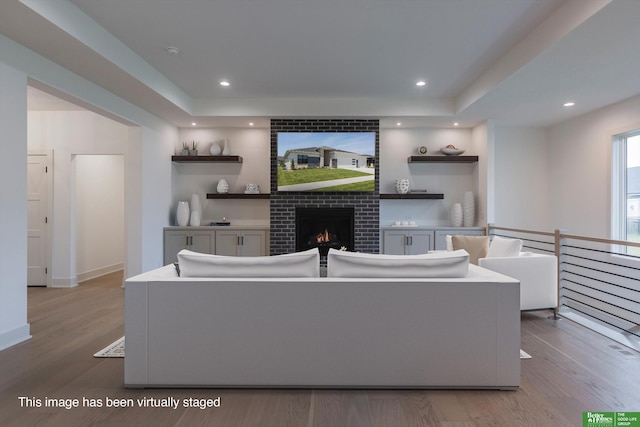 living room with light wood-type flooring and a fireplace