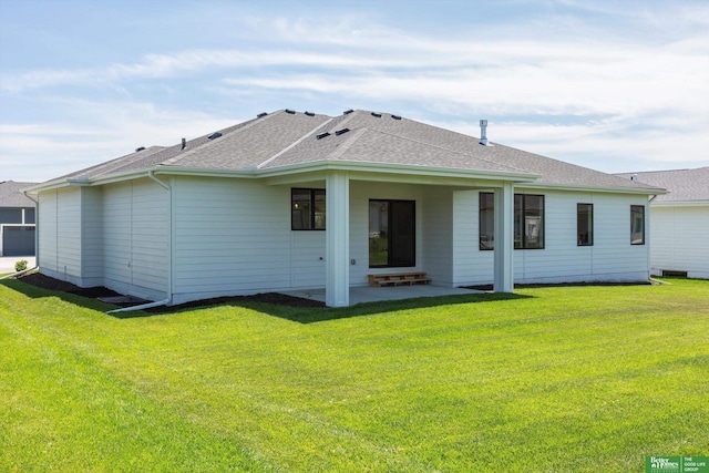 rear view of property with a yard, a shingled roof, and a patio