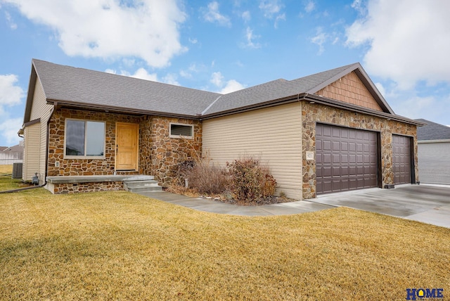 ranch-style home featuring central AC, a garage, and a front lawn