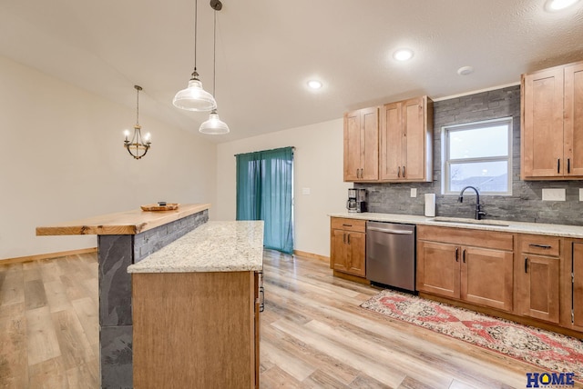 kitchen with a center island, sink, hanging light fixtures, light hardwood / wood-style flooring, and stainless steel dishwasher