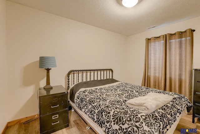 bedroom with hardwood / wood-style flooring