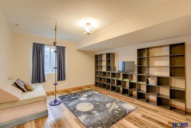 living room with a textured ceiling and hardwood / wood-style flooring