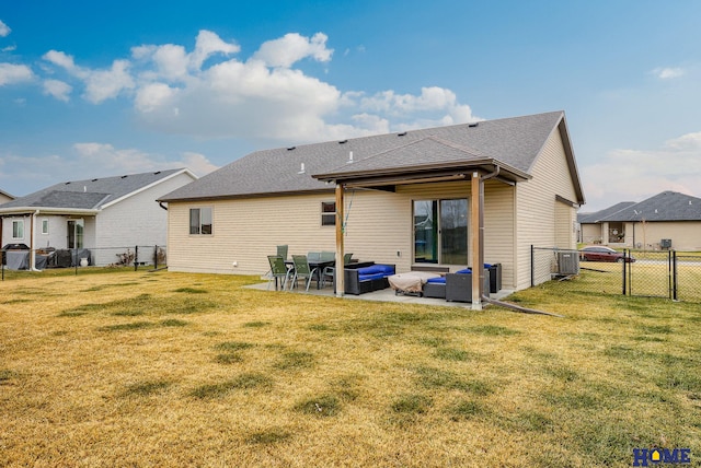 back of house with a lawn, an outdoor living space, a patio area, and central air condition unit