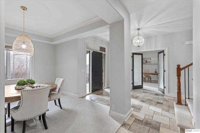 dining space with ornamental molding and an inviting chandelier