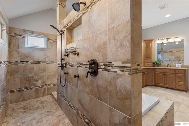 bathroom featuring shower with separate bathtub, vanity, and vaulted ceiling