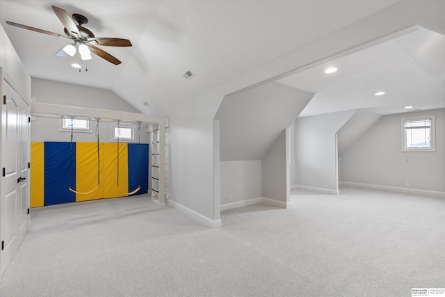 additional living space featuring carpet, ceiling fan, and vaulted ceiling