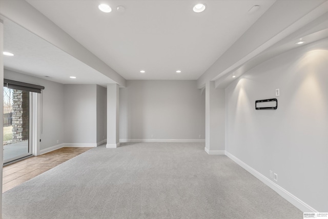 basement featuring light colored carpet