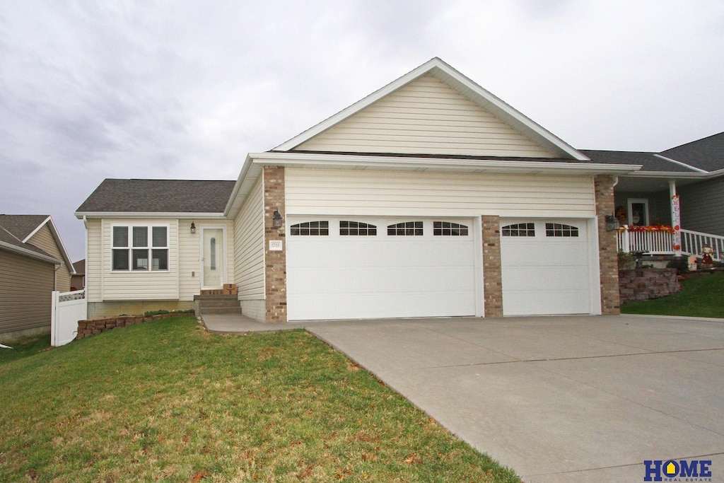 view of front of property with a front lawn and a garage