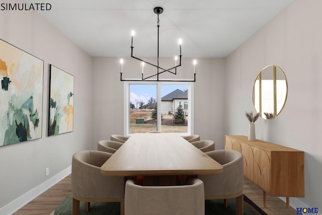 dining area featuring wood-type flooring and a chandelier