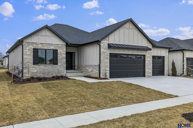 modern inspired farmhouse with a front yard and a garage