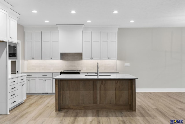 kitchen featuring white cabinets, light wood-type flooring, sink, and stainless steel appliances