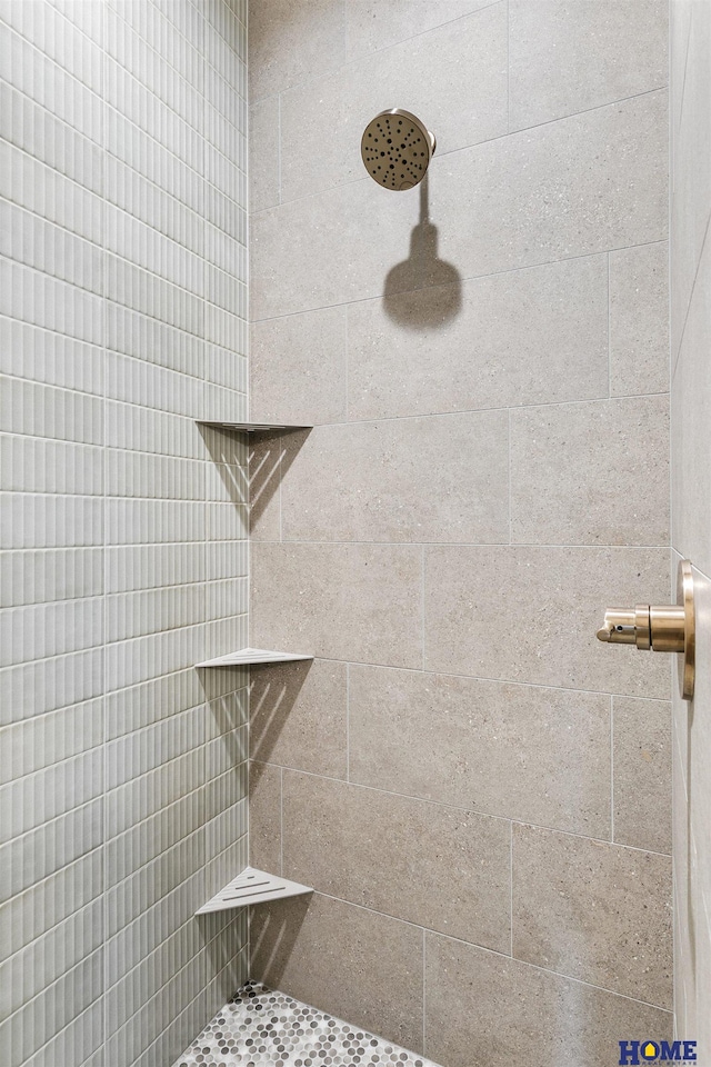 bathroom with a tile shower