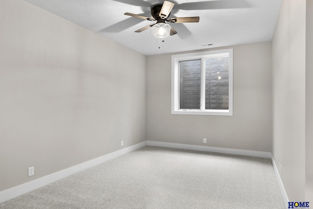 carpeted spare room featuring ceiling fan