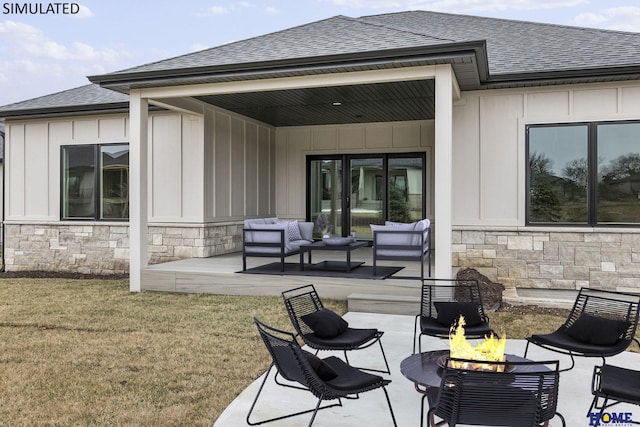 view of patio featuring an outdoor living space with a fire pit