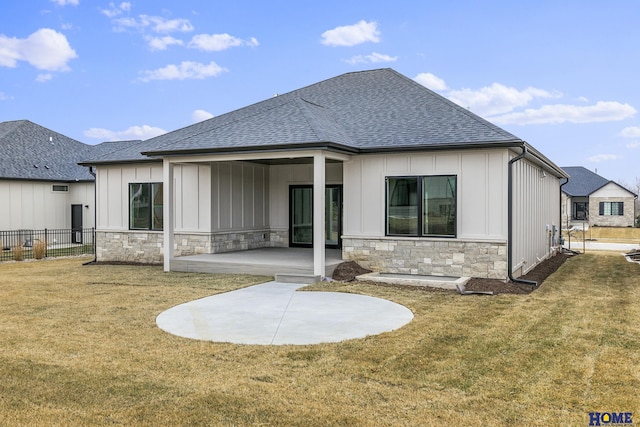 back of house with a lawn and a patio