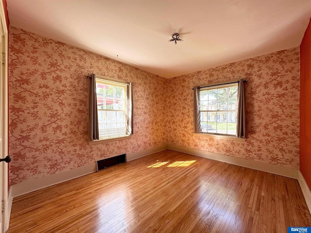 unfurnished room with light hardwood / wood-style floors