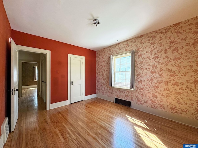 unfurnished bedroom with wood-type flooring and a closet