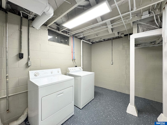 clothes washing area with washing machine and dryer