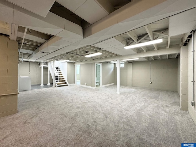 basement featuring carpet and washer / dryer