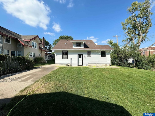 rear view of property featuring a yard