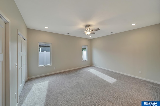 unfurnished bedroom featuring light carpet and ceiling fan