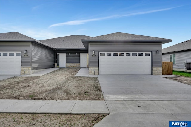 view of front of property with cooling unit and a garage