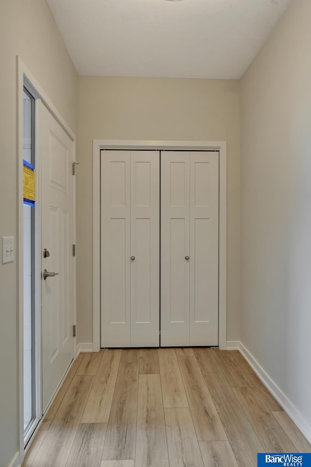 unfurnished bedroom with light hardwood / wood-style floors and a closet