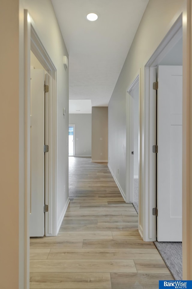 corridor featuring light hardwood / wood-style floors