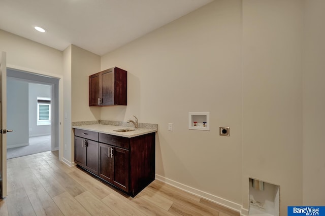 laundry area featuring washer hookup, light hardwood / wood-style floors, electric dryer hookup, and sink