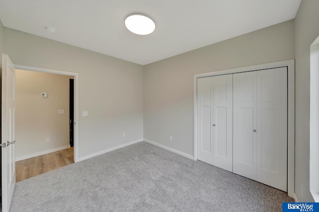 unfurnished bedroom with carpet floors and a closet