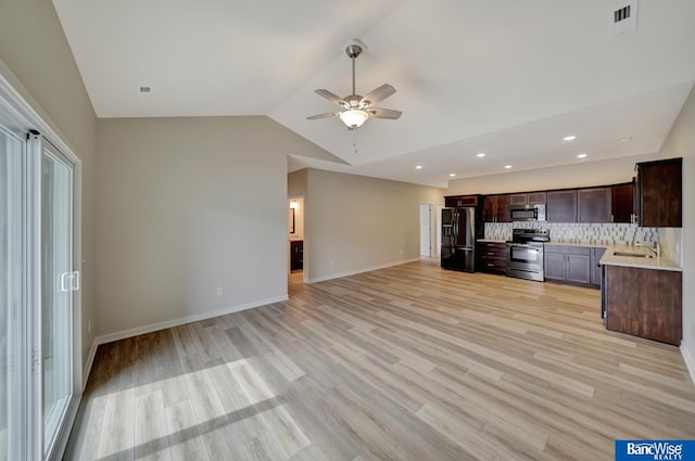 kitchen featuring decorative backsplash, dark brown cabinets, stainless steel appliances, ceiling fan, and lofted ceiling