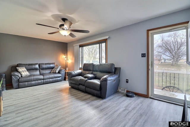 living room with ceiling fan and light hardwood / wood-style floors