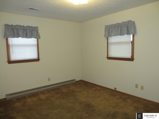 carpeted spare room with a baseboard radiator