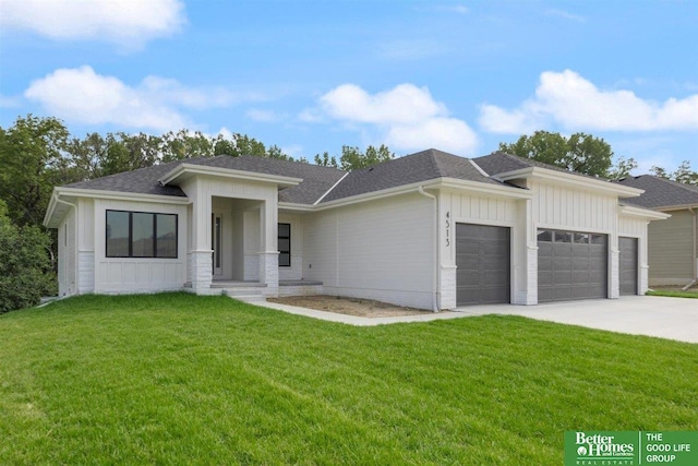 prairie-style home with a garage and a front lawn