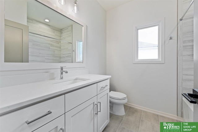 bathroom featuring vanity, toilet, and a tile shower