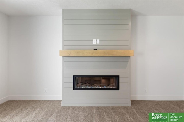 room details featuring carpet and a fireplace