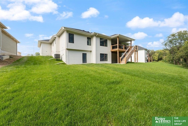 back of house featuring a lawn, a wooden deck, and cooling unit