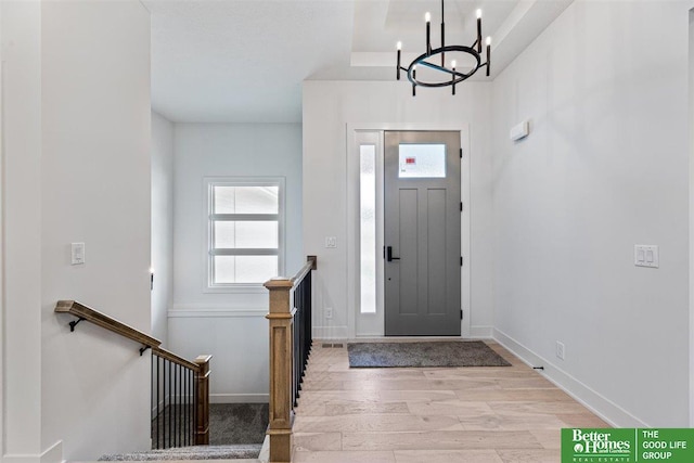 entryway with a chandelier and light hardwood / wood-style floors