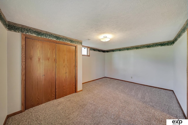 unfurnished bedroom featuring carpet flooring, a textured ceiling, and a closet