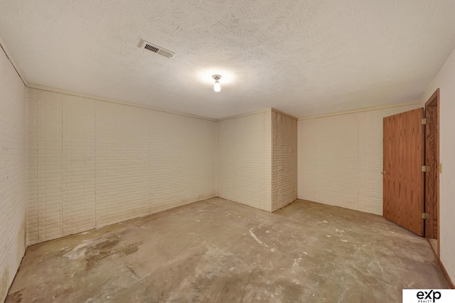 basement featuring a textured ceiling