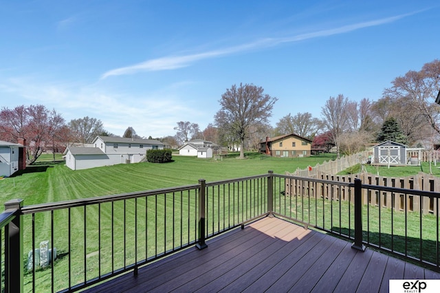 wooden deck featuring a yard and a shed