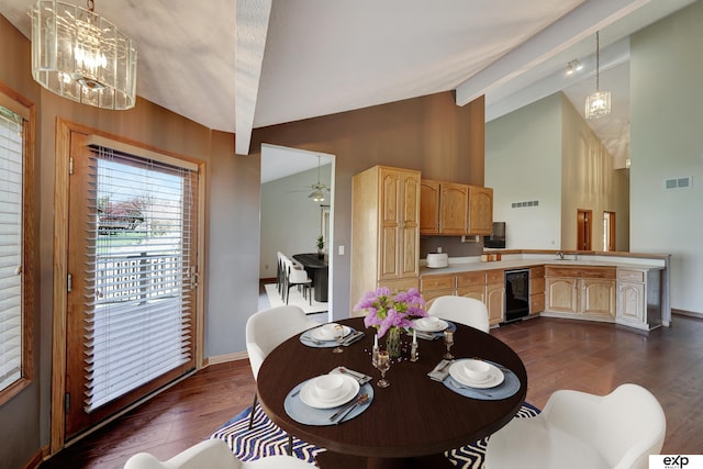 dining area with ceiling fan with notable chandelier, vaulted ceiling with beams, dark hardwood / wood-style floors, and sink