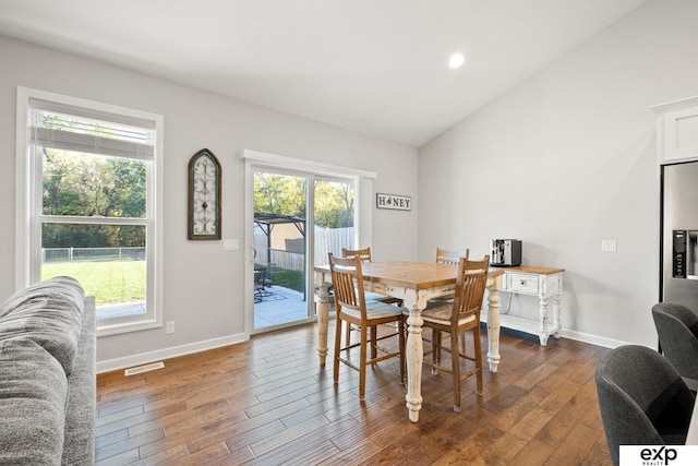 dining area featuring dark hardwood / wood-style floors and lofted ceiling