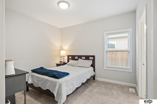 bedroom with light colored carpet