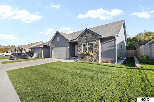 view of front of property featuring a front yard and a garage