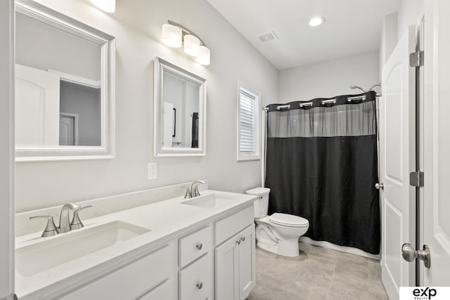 bathroom featuring walk in shower, vanity, and toilet